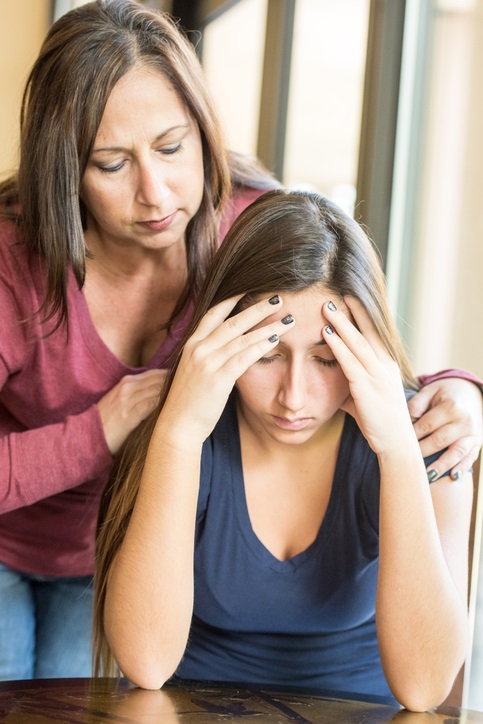 Hispanic mature woman comforting her daughter