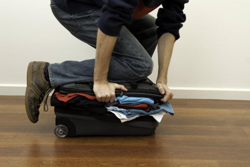 man packing suitcase