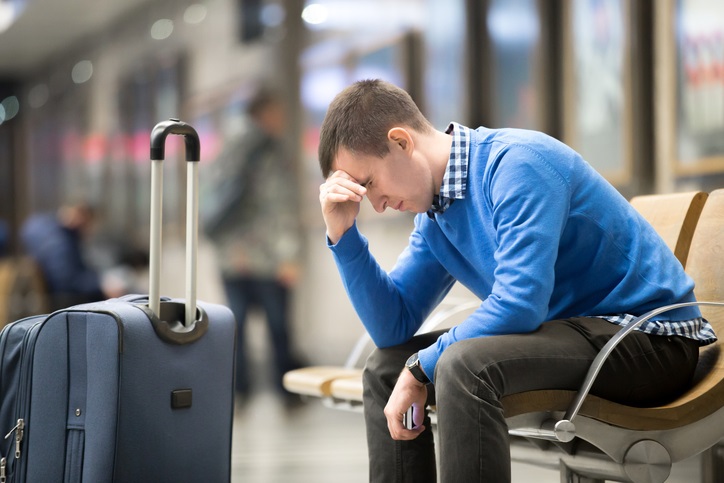Young frustrated man at airport