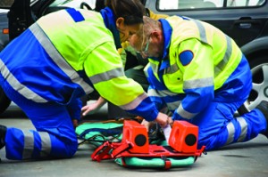 Paramedics help a patient