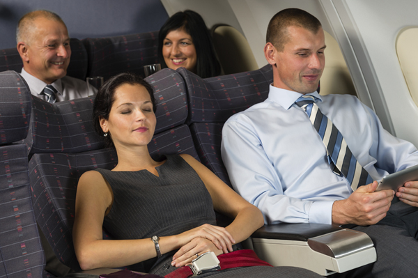 Business travelers relax on a plane