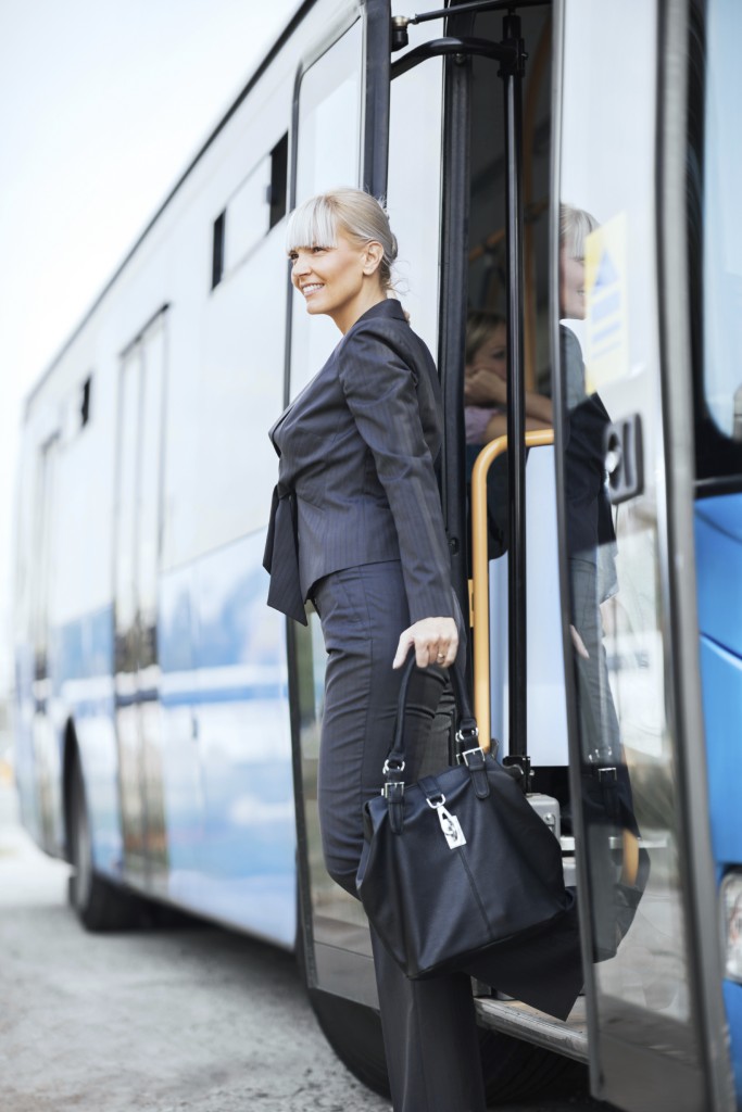 Businesswoman getting off the bus.