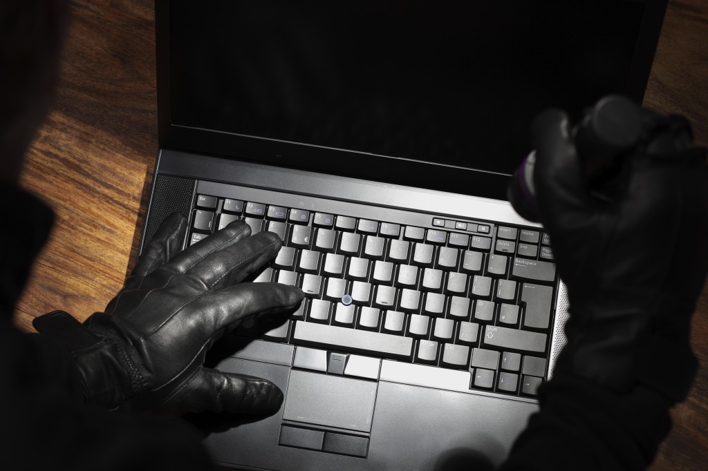 Man stealing data from a laptop