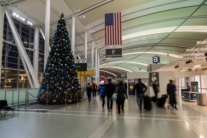 U.S.A. flag and gate number beside Christmas tree